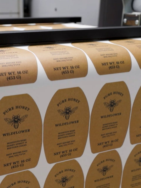 honeystickers-mobile-video-cover Roll of 'Pure Honey Wildflower' labels with bee design.